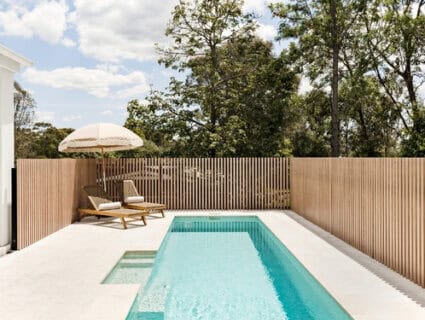 Decobatten square aluminium battens with a timer look finish used as a pool fence.