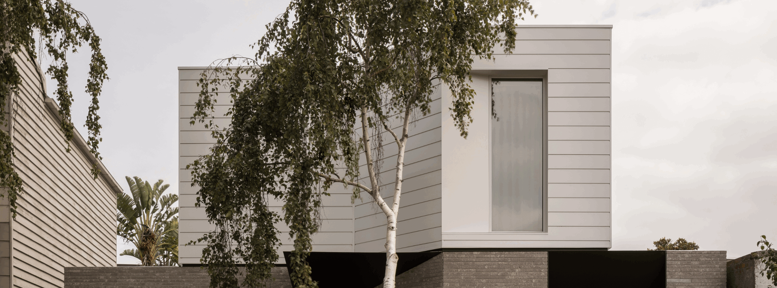 ProjectProfile-Arli Homes- DecoClad_White_Banner
